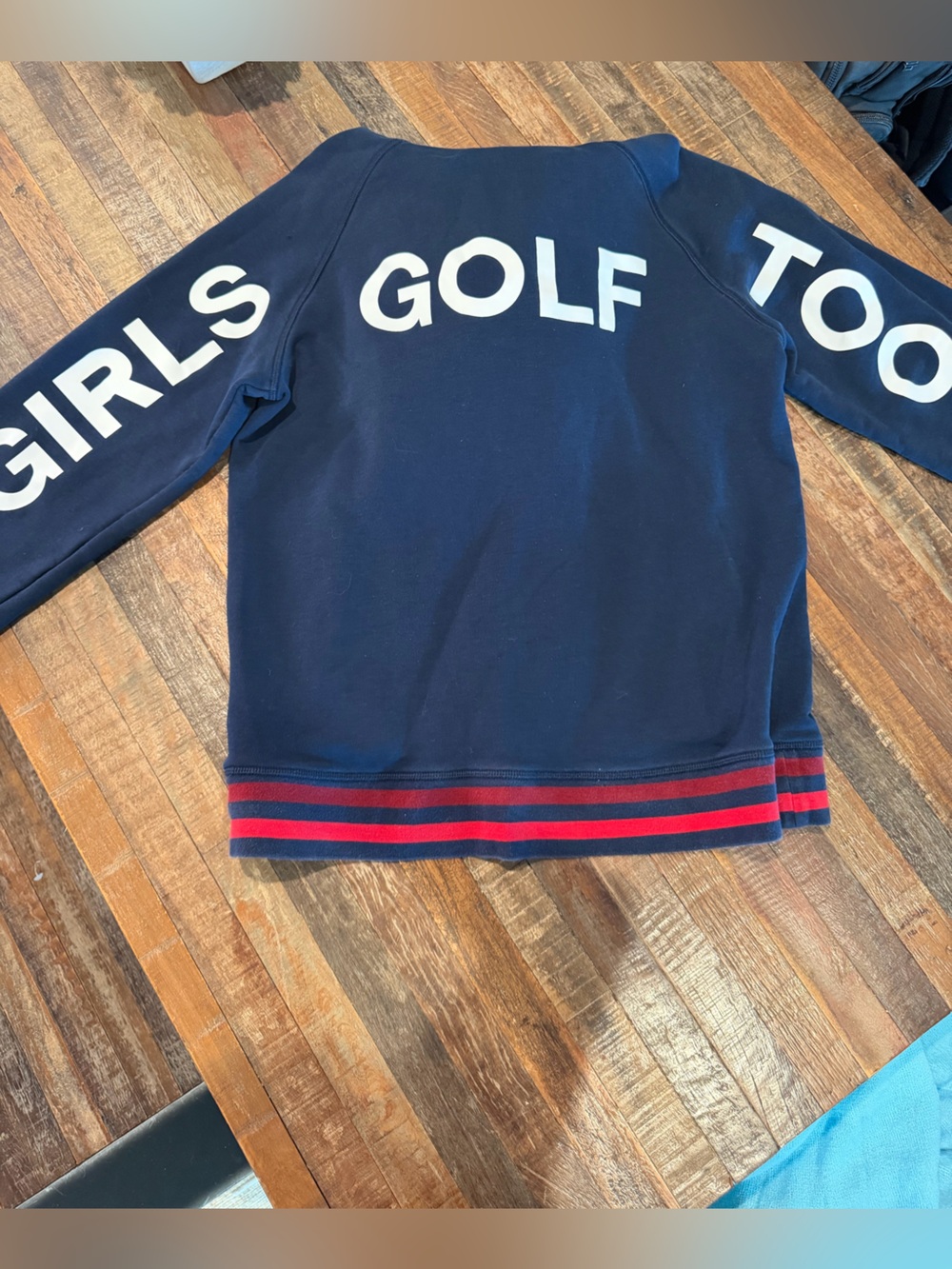 G/FORE Navy Blue Sweater with White Lettering and Red Stripe Hem